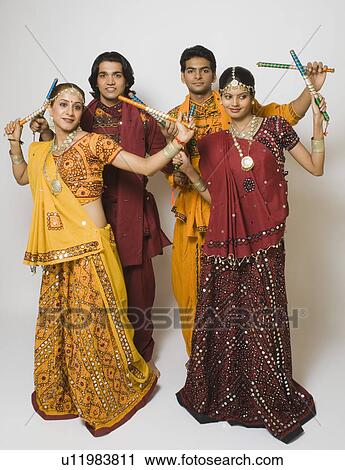 Couples performing dandiya View Large Photo Image Stock Image - Couples performing dandiya. Fotosearch