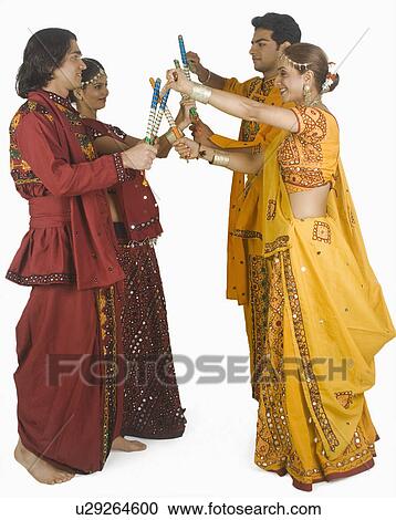 Couples performing dandiya View Large Photo Image Stock Image - Couples performing dandiya. Fotosearch