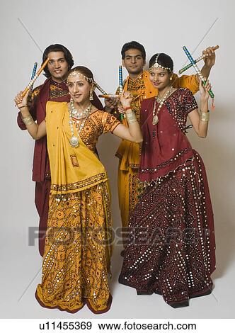 Couples performing dandiya View Large Photo Image Stock Photo - Couples performing dandiya. Fotosearch