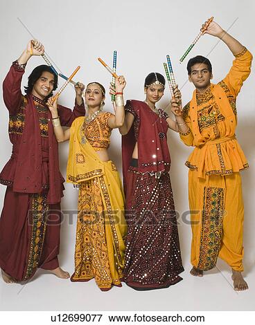 Stock Photo - Couples performing dandiya. Fotosearch