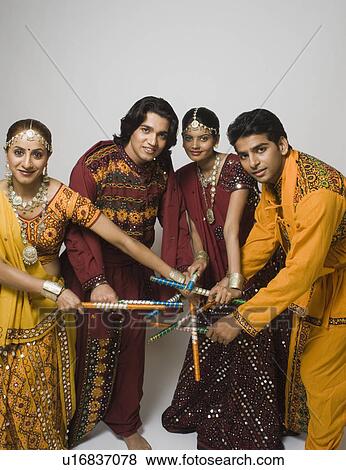 Stock Photo - Couples performing dandiya. Fotosearch