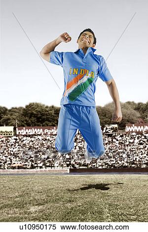 Stock Photography - Cricket bowler celebrating his success in a stadium. Fotosearch