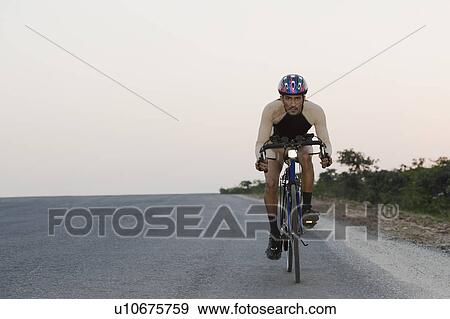 Cyclist on a racing bicycle View Large Photo Image Stock Photo - Cyclist on a racing bicycle. Fotosearch