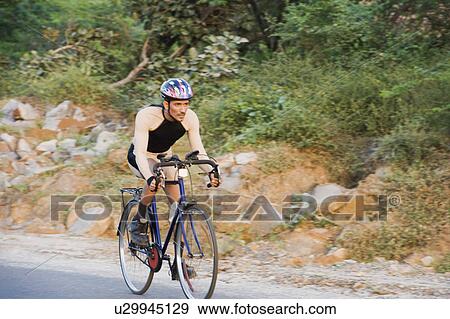 Cyclist on a racing bicycle View Large Photo Image Stock Photo - Cyclist on a racing bicycle. Fotosearch