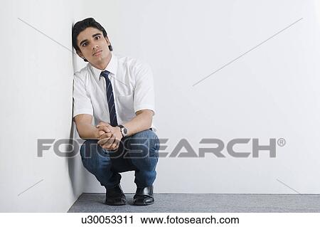 Stock Image - Disappointed university student in the corner. Fotosearch