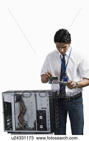 Engineering student examining a computer board before assembling View Large Photo Image Stock Image - Engineering student examining a computer board before assembling. Fotosearch