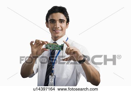 Engineering student holding an electronic circuit board View Large Photo Image Picture - Engineering student holding an electronic circuit board. Fotosearch