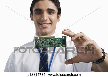 Engineering student holding an electronic circuit board View Large Photo Image Picture - Engineering student holding an electronic circuit board. Fotosearch