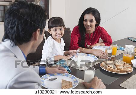 Stock Image - Family at a breakfast table. Fotosearch