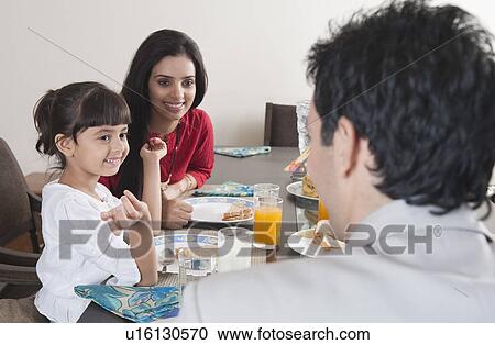 Stock Image - Family at a breakfast table. Fotosearch