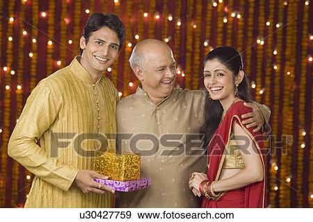 Stock Photo - Family at Diwali occasion smiling. Fotosearch