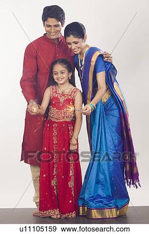 Family celebrating Diwali View Large Photo Image Stock Photo - Family celebrating Diwali. Fotosearch