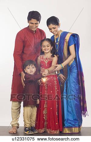 Stock Photography - Family celebrating Diwali. Fotosearch