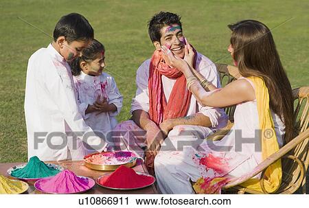 Family celebrating Holi in a garden View Large Photo Image Stock Image - Family celebrating Holi in a garden. Fotosearch