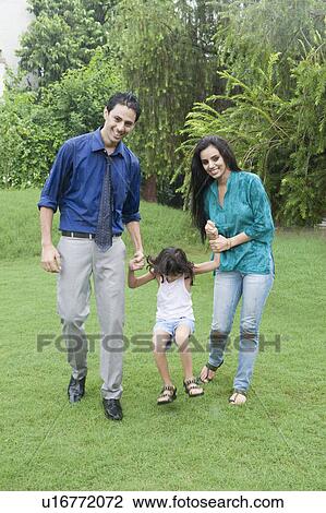 Family enjoying in rain in a park View Large Photo Image Stock Image - Family enjoying in rain in a park. Fotosearch