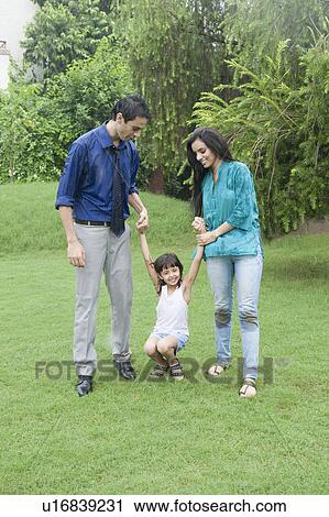 Family enjoying in rain in a park View Large Photo Image Stock Image - Family enjoying in rain in a park. Fotosearch