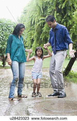 Family enjoying in rain in a park View Large Photo Image Stock Image - Family enjoying in rain in a park. Fotosearch