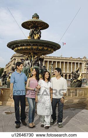 Stock Image - Family in front of a fountain, Paris, France. Fotosearch