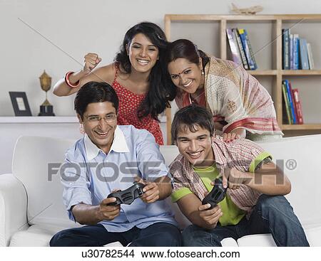 Picture - Family playing video game. Fotosearch