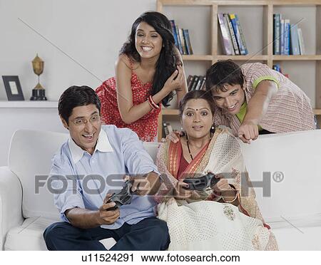 Stock Image - Family playing video game. Fotosearch