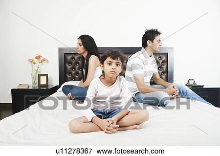 Family sitting back to back View Large Photo Image Stock Photo - Family sitting back to back. Fotosearch