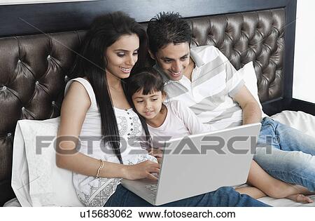 Family using a laptop View Large Photo Image Stock Image - Family using a laptop. Fotosearch