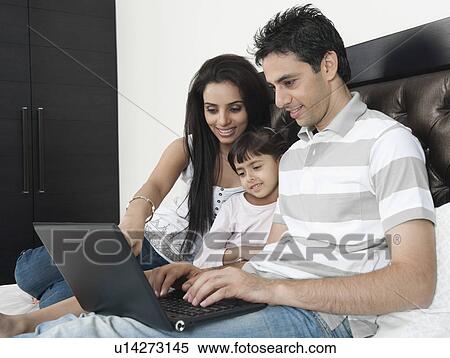 Stock Photography - Family using a laptop. Fotosearch