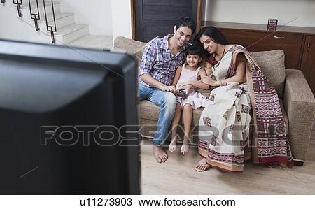 Family watching television View Large Photo Image Stock Image - Family watching television. Fotosearch