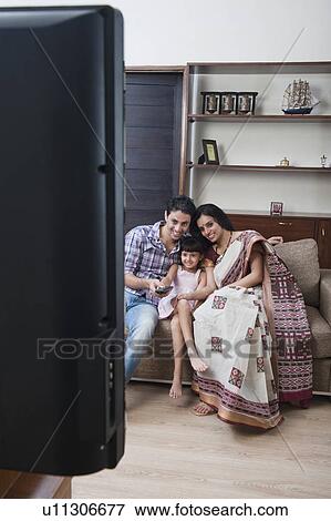 Family watching television View Large Photo Image Stock Photo - Family watching television. Fotosearch
