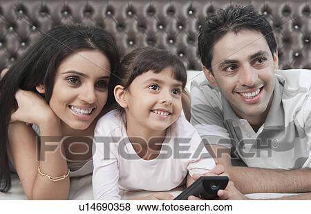 Stock Photo - Family watching television. Fotosearch