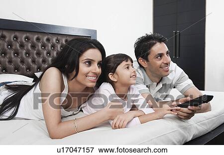Family watching television View Large Photo Image Stock Photo - Family watching television. Fotosearch