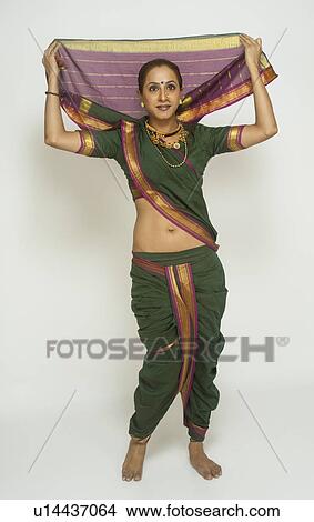 Picture - Female folk dancer dancing in traditional Maharashtrian dress. Fotosearch