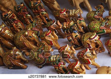 Stock Image - Figurines of elephants at a market stall, New Delhi, India. Fotosearch