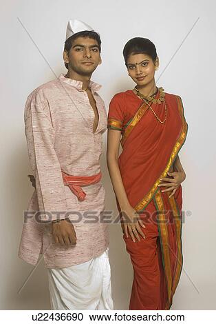 Stock Image - Folk dancers standing together in traditional Maharashtrian dress. Fotosearch