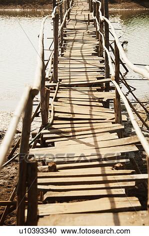 Stock Image - Footbridge across a lagoon, Goa, India. Fotosearch