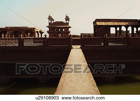Stock Image - Footbridge across a pond in a palace, Fatehpur Sikri, Agra, Uttar Pradesh, India. Fotosearch
