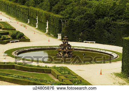 Stock Photograph - Fountain in a formal garden, Chateau de Versailles, Versailles, Paris, France. Fotosearch