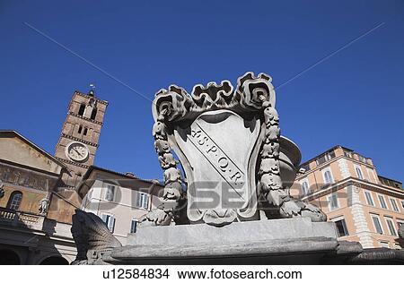 Picture - Fountain with Basilica di Santa Maria in the background, Piazza di Santa Maria in Trastevere, Rome, Lazio, Italy. Fotosearch