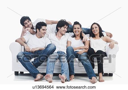 Friends having fun on a couch View Large Photo Image Picture - Friends having fun on a couch. Fotosearch