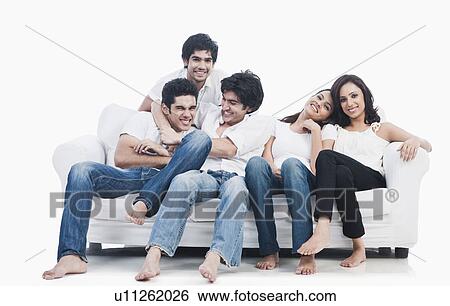 Stock Photograph - Friends having fun on a couch. Fotosearch