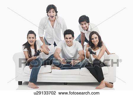 Stock Image - Friends playing video game. Fotosearch