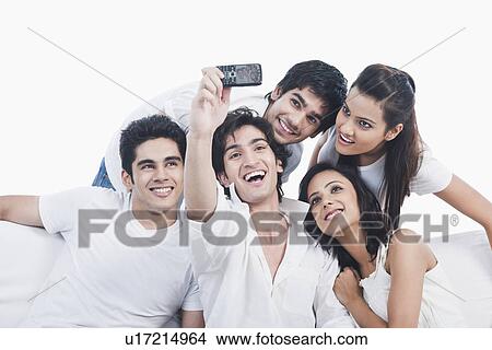 Friends taking picture of themselves with a mobile phone View Large Photo Image Picture - Friends taking picture of themselves with a mobile phone. Fotosearch