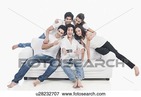 Friends taking picture of themselves with a mobile phone View Large Photo Image Stock Photo - Friends taking picture of themselves with a mobile phone. Fotosearch