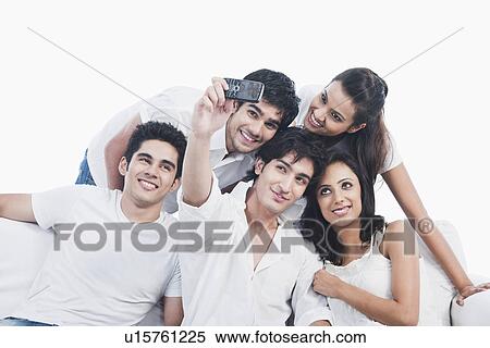 Friends taking picture of themselves with a mobile phone View Large Photo Image Stock Photography - Friends taking picture of themselves with a mobile phone. Fotosearch