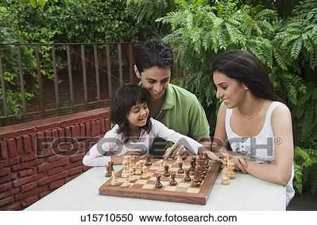 Girl playing chess with her parents View Large Photo Image Stock Image - Girl playing chess with her parents. Fotosearch