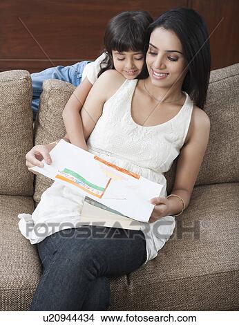 Picture - Girl showing drawing of Indian flag to her mother. Fotosearch