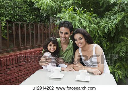 Stock Image - Girl smiling with her parents. Fotosearch