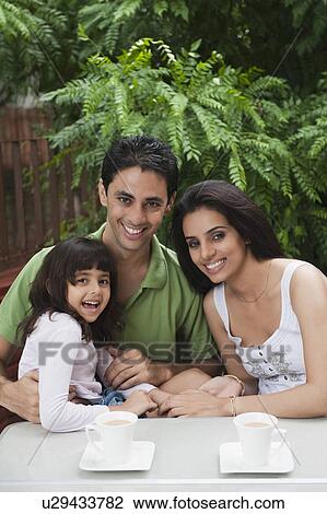 Stock Image - Girl smiling with her parents. Fotosearch