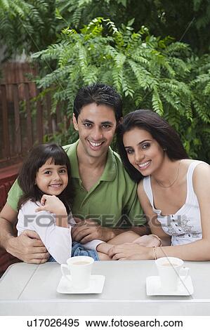 Girl smiling with her parents View Large Photo Image Stock Photography - Girl smiling with her parents. Fotosearch
