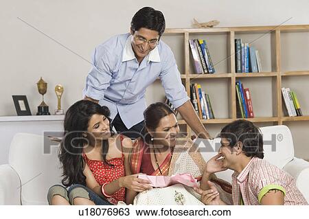 Stock Image - Happy family in a living room. Fotosearch